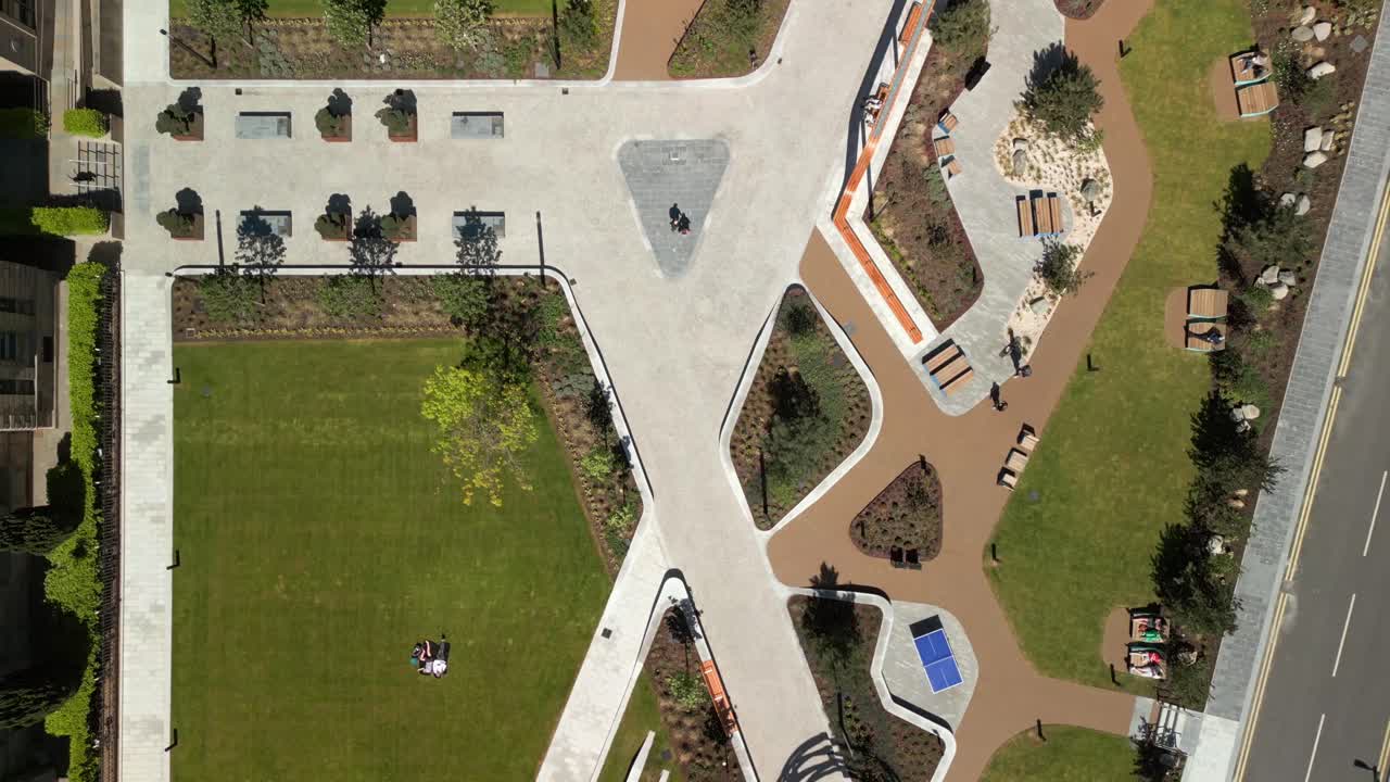 Overhead rising aerial video of City Quays Gardens in Belfast, Northern Ireland, UK on a bright and sunny day. Produced in 4K, 60FPS and with Rec709 color.