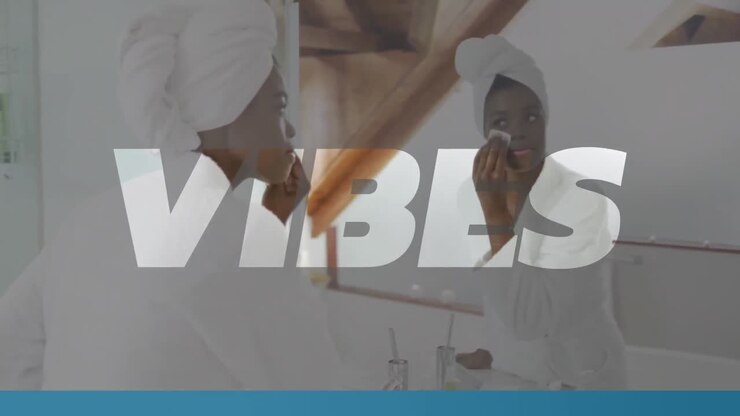 Animation of vibes text in white over african american woman cleansing face in bathroom at home