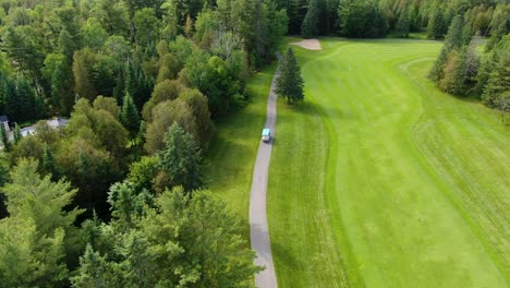 drone following a golf cart driving on a pathway