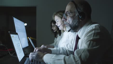 side view of teleworkers using laptops