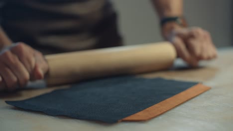 leather crafting: rolling out leather with a rolling pin