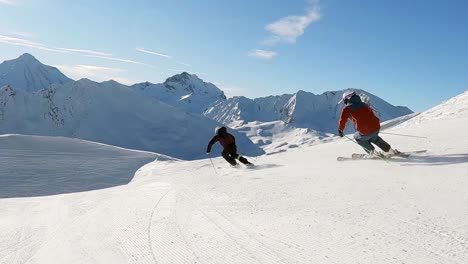 panorama alpine skiing of two male ski professionals in the swiss mountains with amazing view on the wild mountain range coverd with fresh snow