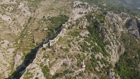 hillside walls of kotor fortress in montenegro, mountain fortifications of kotor, aerial view