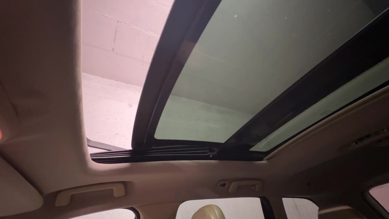 A wideangle shot showing a large panoramic sunroof sliding open inside a modern luxury SUV, revealing a bright ceiling. Ideal for automotive technology and lifestyle content.