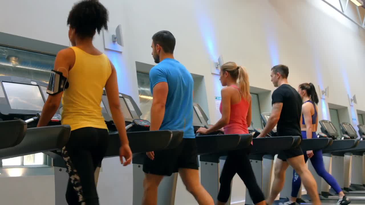 Fit people walking on treadmills