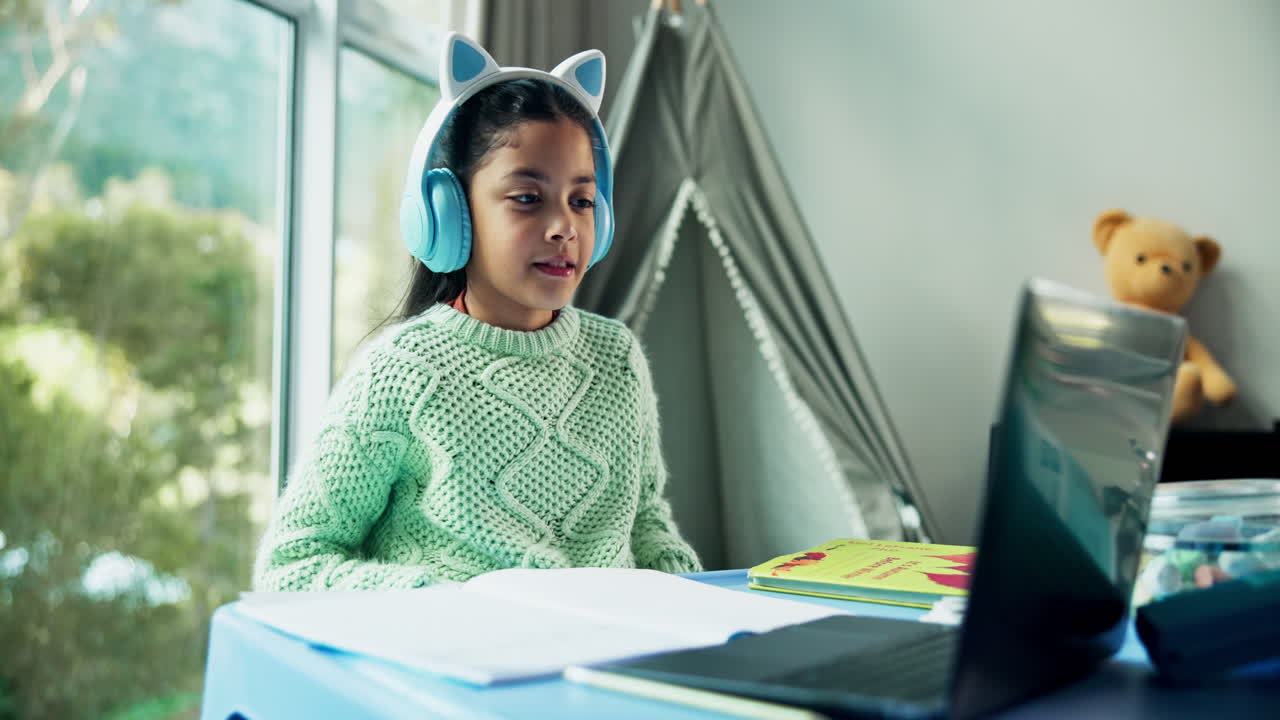 Girl with Headphones Using Laptop for Online Learning