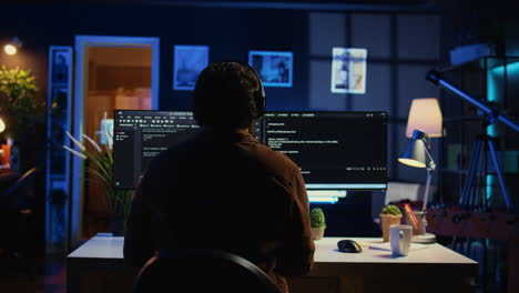 engineer wearing headphones while using coding to fortify it security