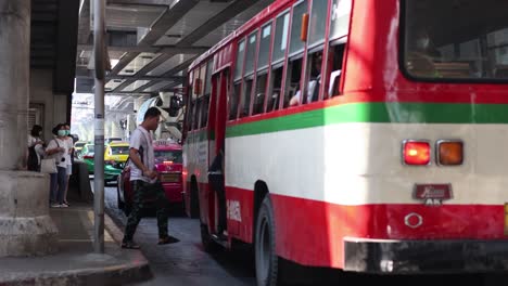 people at a bus stop during daily commute