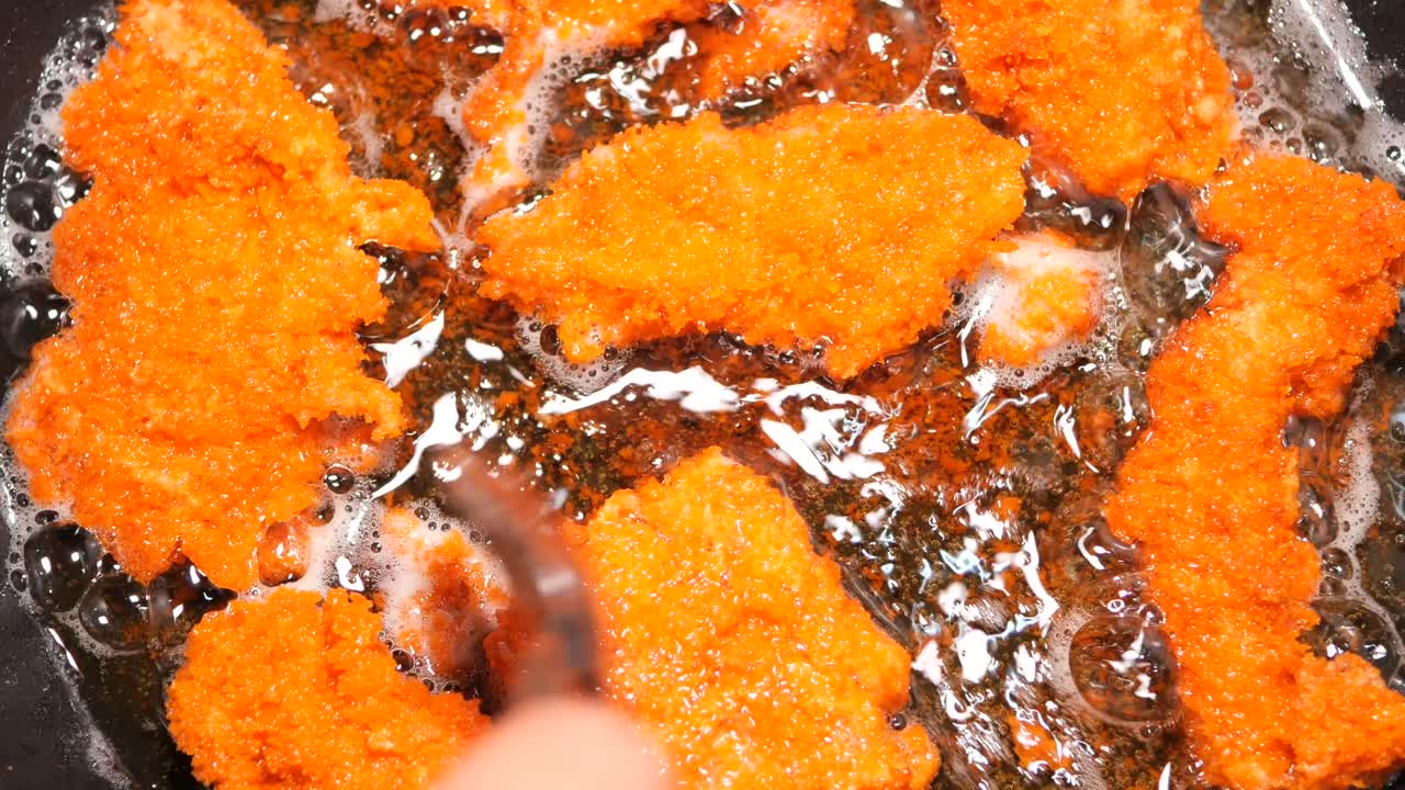Crispy Breaded Pork Cutlets Frying in a Pan