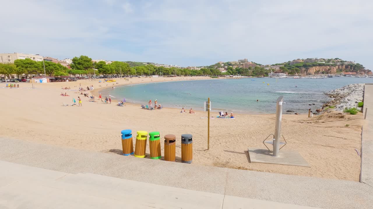 Sant Feliu de Gu&iacute;xols on the Costa Brava of Gerona Spain tourist town there are garbage containers on the beach