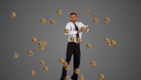 animation of emoji icons over caucasian businessman using tablet