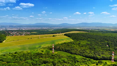 hills and fields landscape. vast green fields stretch beneath clear blue skies, while hills rise in the distance, showcasing a serene rural scene