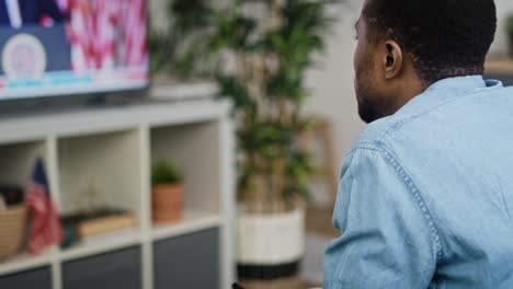 Tilt-up-video-of-man-watching-TV