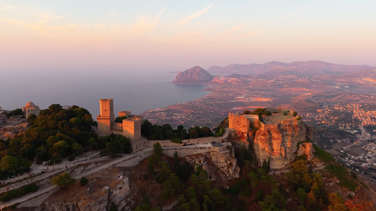 Ancient Castle Of Venus In Mount Erice With Coastal Towns, Mount Cofano, And Tyrrhenian Sea At Sunset In The Background In Sicily, Italy