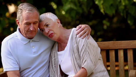 elderly couple sitting on a bench