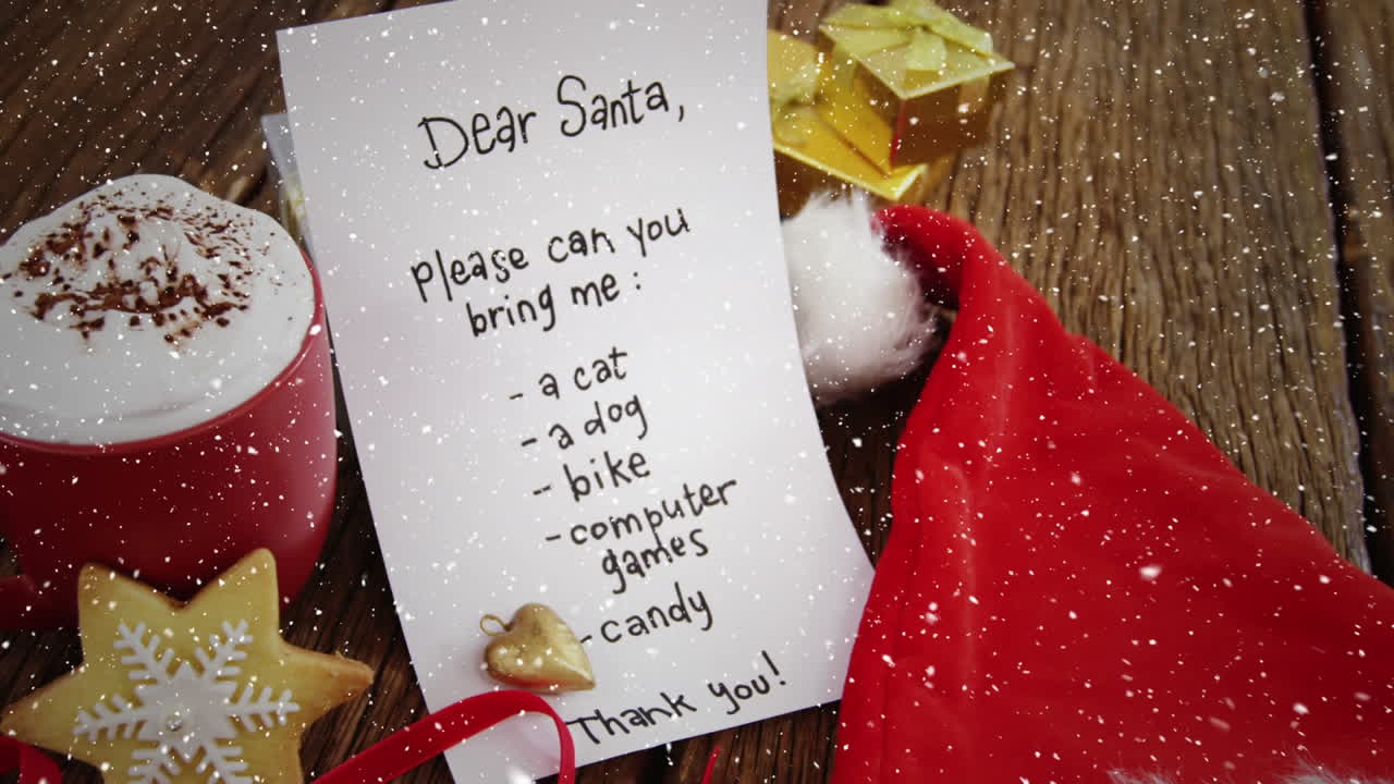 크리스마스 장식과 가득 찬 소원 목록과 함께 책상 위에 눈이 내리는 비디오 구성