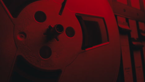 a close-up on a vintage tape recorder in a red blinking light
