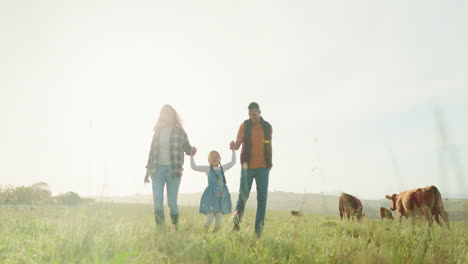 man, woman or child holding hands on farm