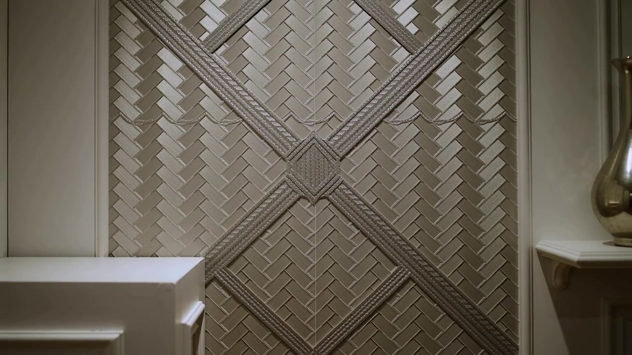 Panning camera after operator starting slow pull in foyer revealing woven wall panel and vase