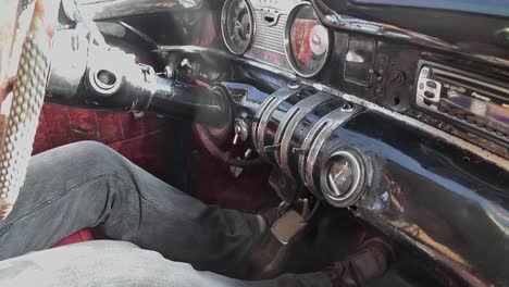 inside view of the cockpit of a typical and classic vintage cuban taxi transporting tourists through havana