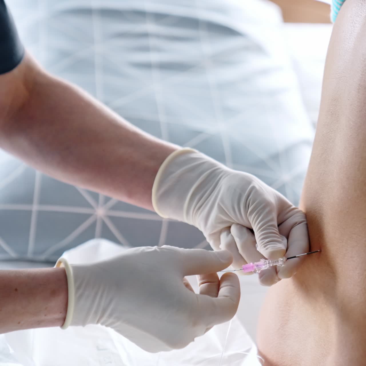 Gloved hands of a doctor giving epidural anesthesia to a patient's back. Preparation for the child birth