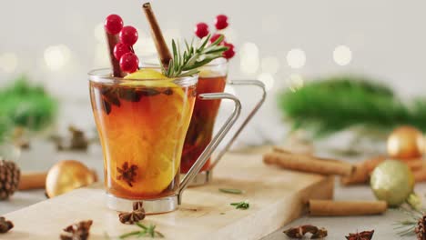 video of cups of hot tea with cinnamon and lemon over white background