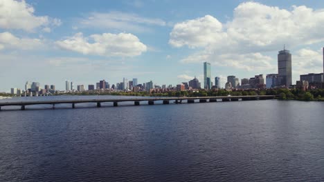 drone circling over charles river in boston massachusetts with view of harvard bridge