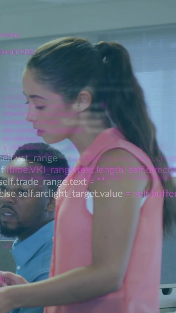 Vertical video: Woman leaning over monitor causing code banding and showing business task to peer