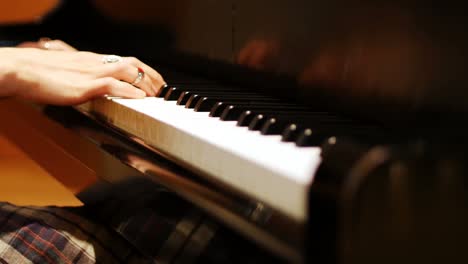 close-up of woman playing a piano