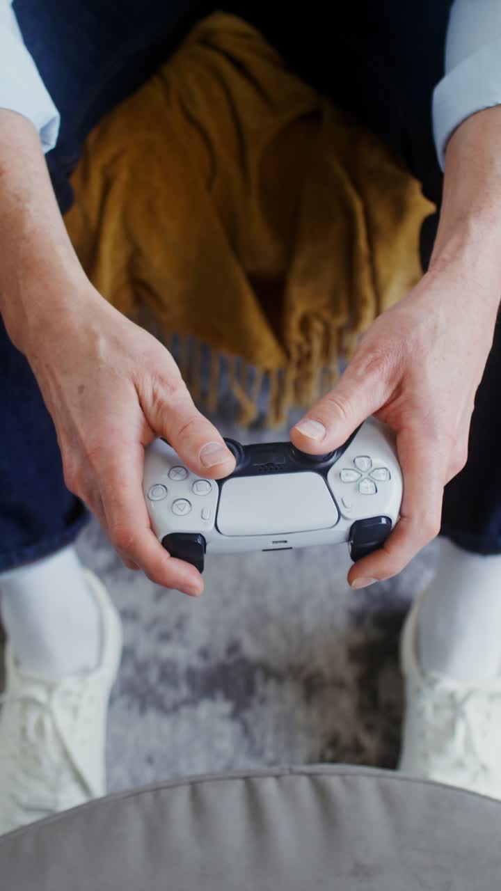 Person holding a Playstation controller
