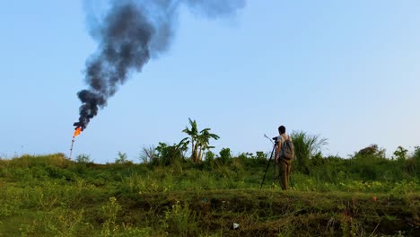 Environmental-pollution,-emission-from-smokestacks-in-gas-plants,-close-up-of-documentary-photographer