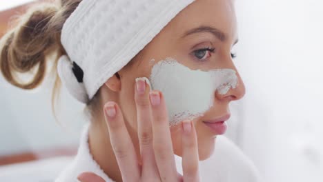 Close-up-view-of-woman-applying-face-mask