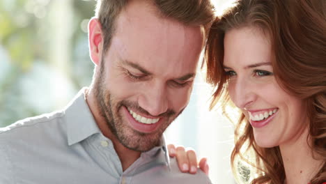 smiling couple with engagement ring