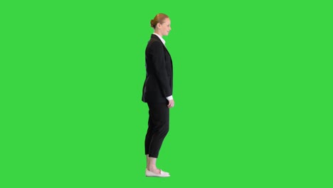 beautiful young woman in formal outfit smiling to camera on a green screen, chroma key