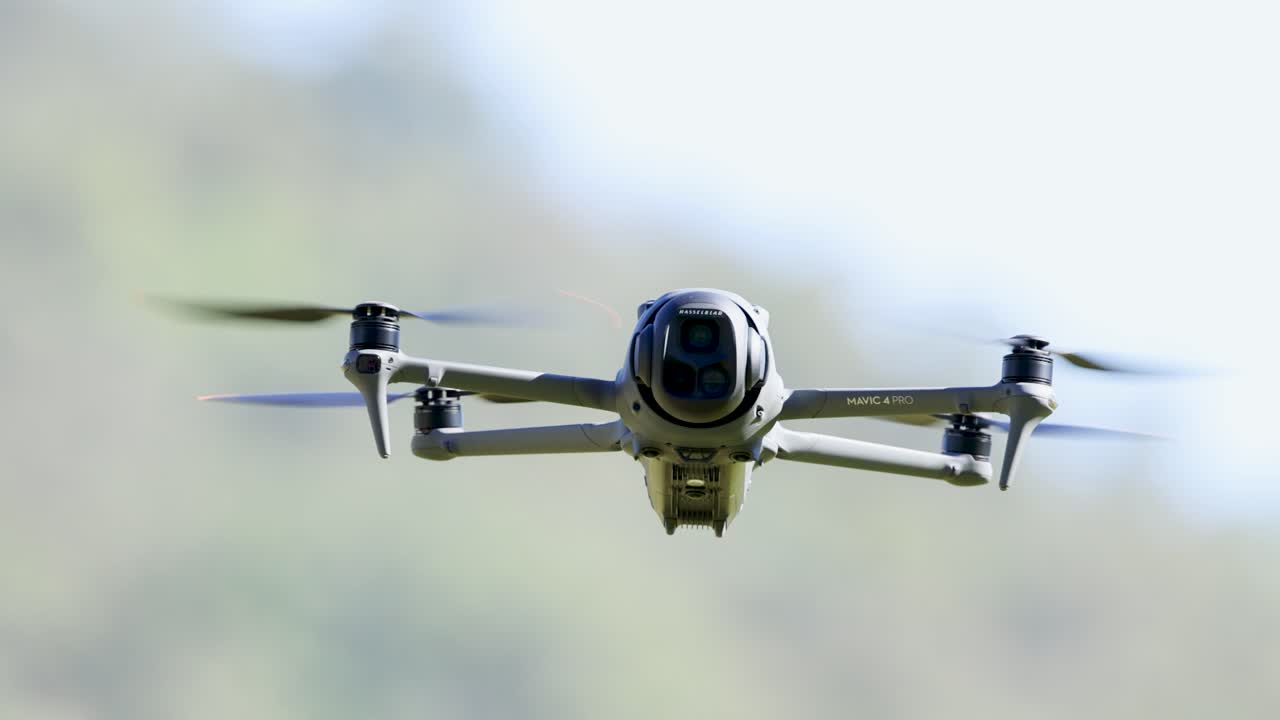 A drone hovers steadily in clear skies over Gold Coast, Australia, captured in slow motion with blurred background