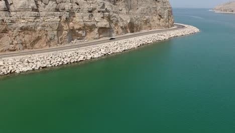 following car passing over boat musandam sultanate of oman