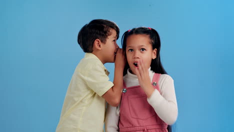 two children whispering secrets to each other