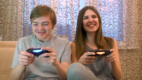 couple playing video games at home