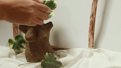 showcasing a handcrafted female body shaped vase made of recycled egg carton dry clay, diy craft project