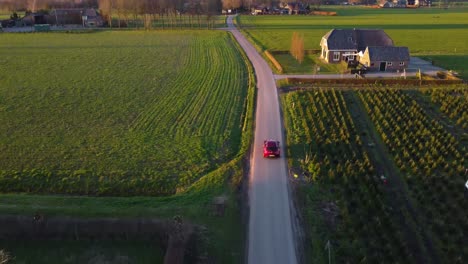 Alfa-Romeo-car-being-driven-in-beautiful-weather-on-a-farm-road