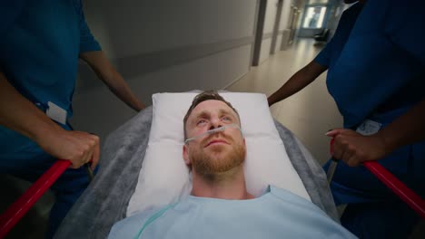 patient being transported by nurses in a hospital corridor