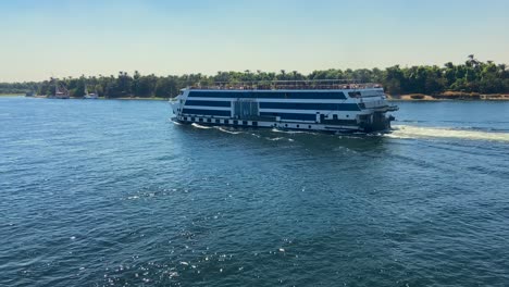 large touristic cruise navigating through the waters of nile river in egypt