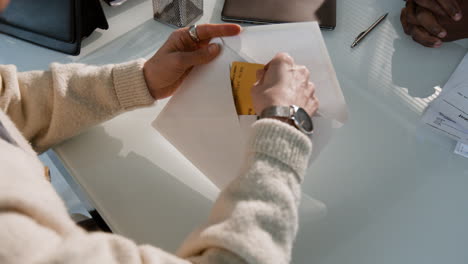 business meeting - exchange of documents and credit card