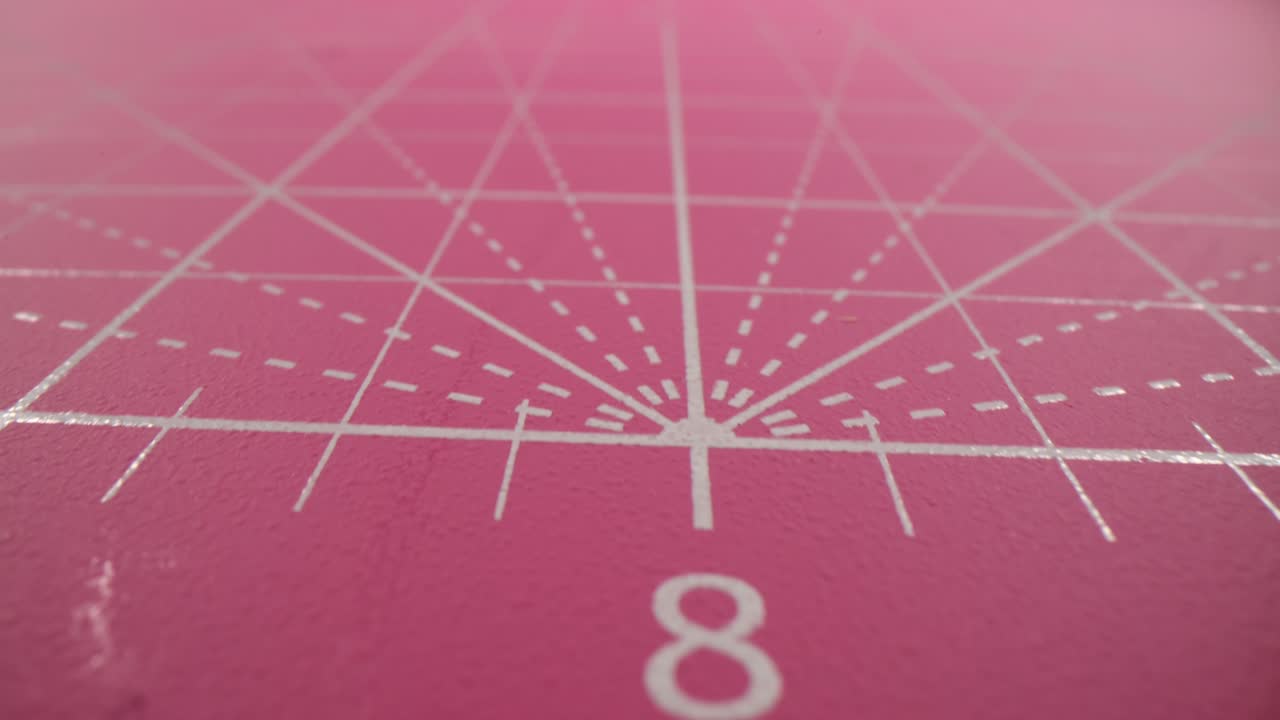 Close-up of a Pink Cutting Mat with White Grid Lines