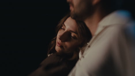 a woman leaning on a man's shoulder in a tender moment