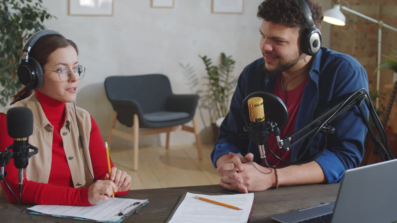 Male and Female Podcast Presenters Having Discussion