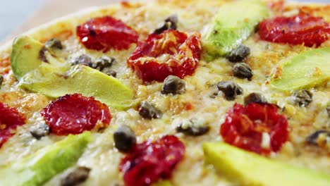 Pizza-Al-Horno-Con-Aderezos-De-Aguacate,-Tomate-Cherry-Y-Aceitunas