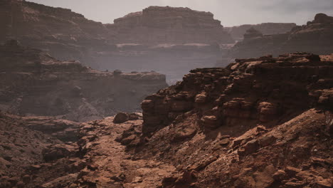 misty morning light over rugged canyon landscape with steep cliffs