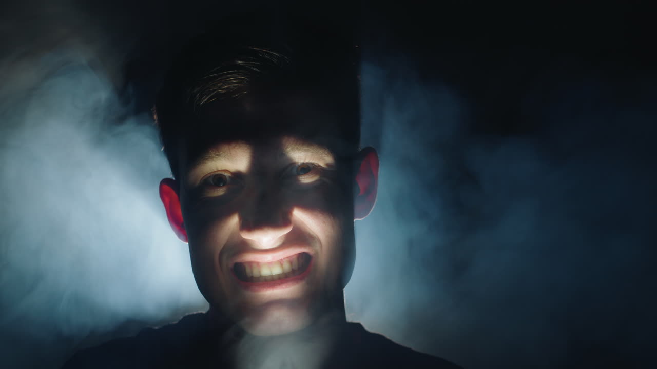 A Young Man with Intense Expression in Smoky Darkness