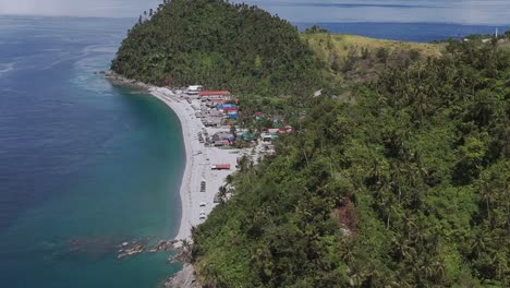 Looc-Beach-in-Surigao,-Philippines,-on-a-bright-clear-day-with-turquoise-waters-and-lush-jungle-hills